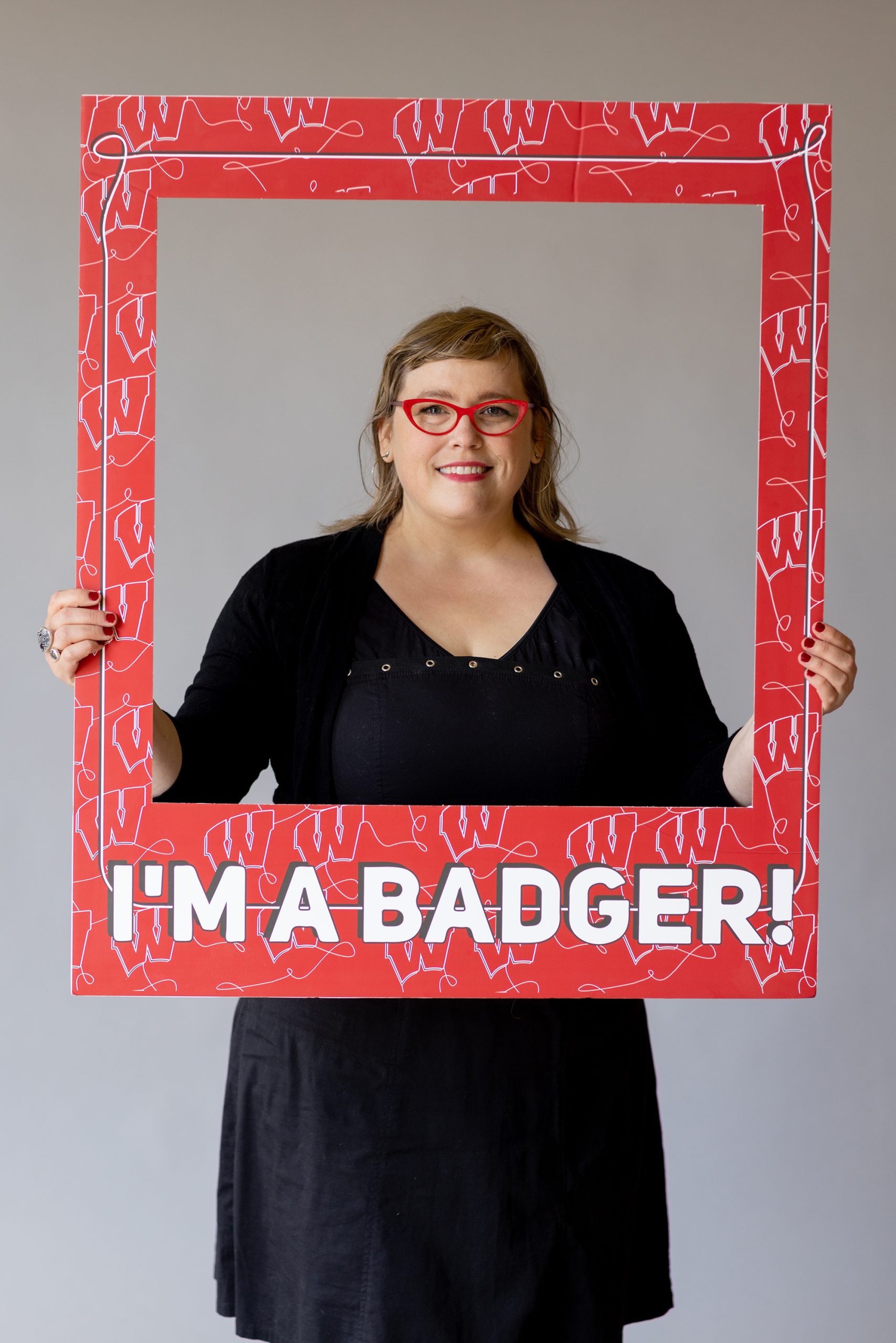 Student with the I'm a Badger frame